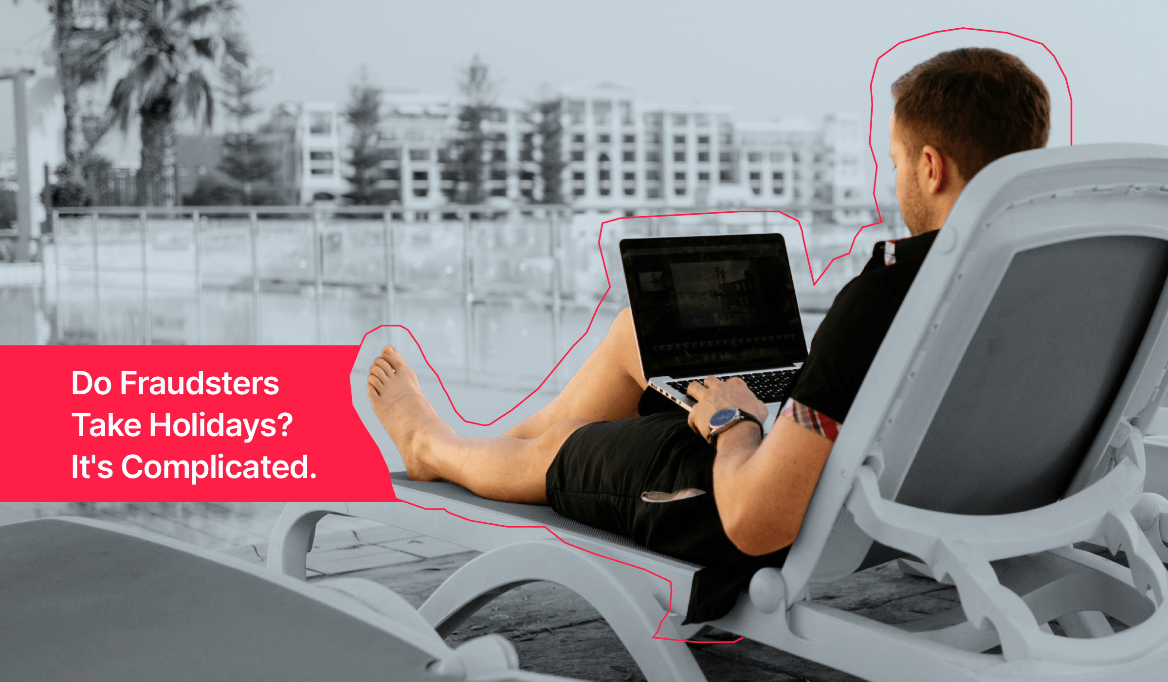 Image of a man in a beach chair, working on his laptop.